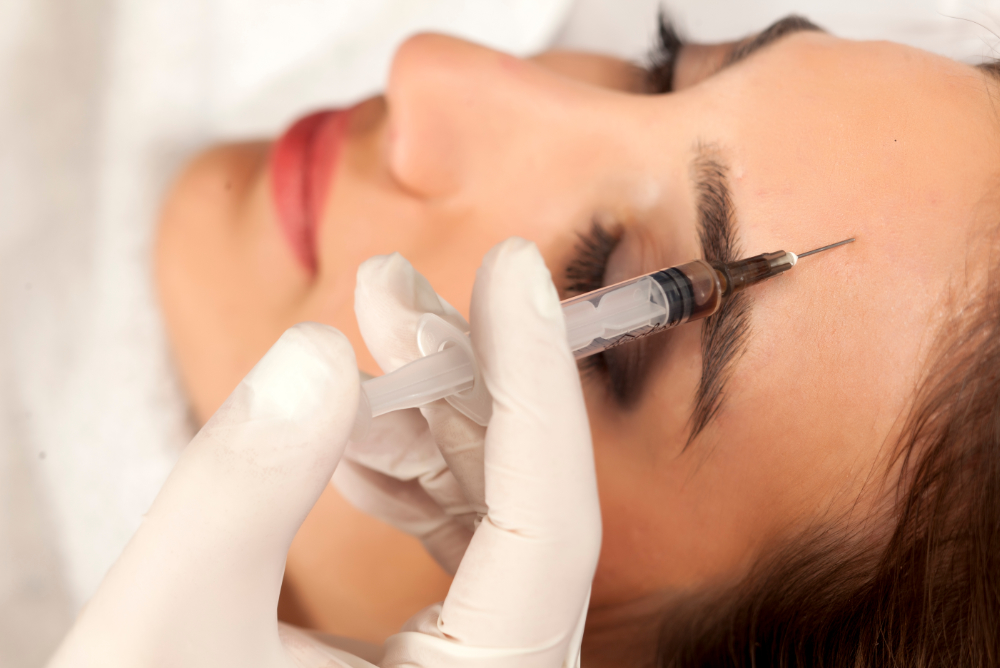 woman being treated with Botox to forehead