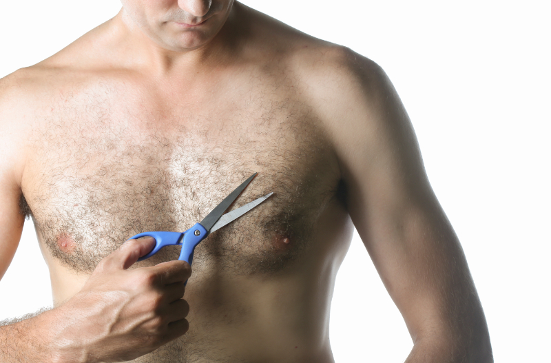man clipping chest hair